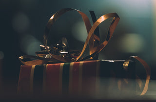 A wrapped present with golden ribbons