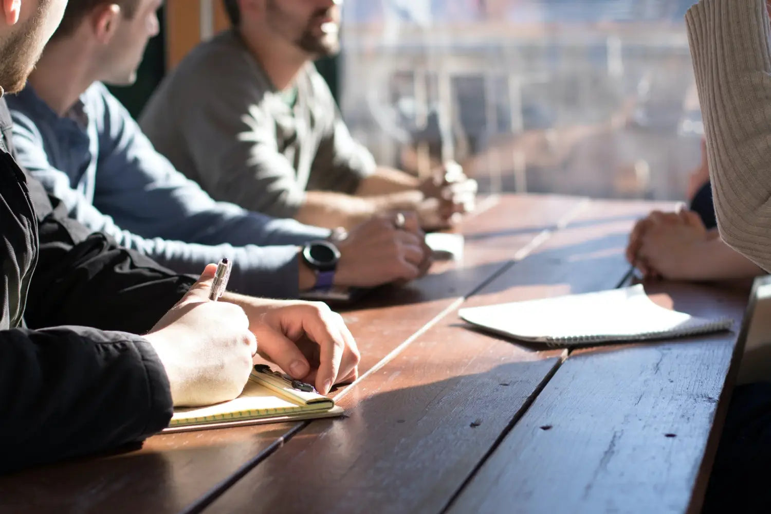 A group of people sitting around a table for a job interview